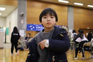 完成した時計をつける子ども